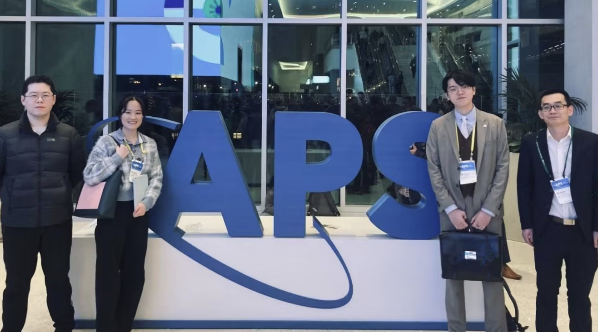 Stevens students pose in front of American Physical Society sign.